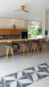 a kitchen with chairs and a counter with a fireplace at Garden House Jepara in Jepara