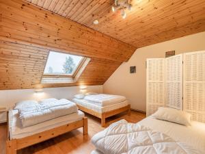 two beds in a room with a wooden ceiling at Gite in Lessive close to Rochefort in Rochefort