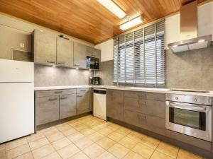 a kitchen with stainless steel appliances and a wooden ceiling at Gite in Lessive close to Rochefort in Rochefort