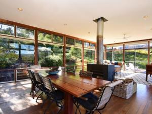 a large living room with a wooden table and chairs at Budderoo Unique with 270 degree views in Upper Kangaroo River