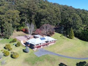 an aerial view of a house with a solar roof at Wild Peace Mountain Lodge Kangaroo Valley in Bellawongarah