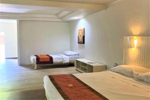 Postel nebo postele na pokoji v ubytování The Yani Hotel Bali