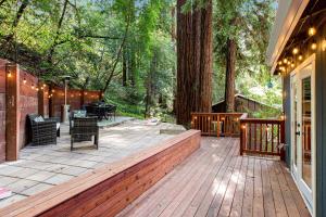 a large wooden deck with a table and chairs at Canyon House in Guerneville