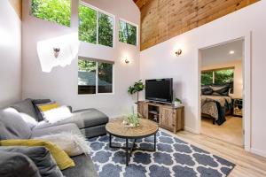 a living room with a couch and a tv at Canyon House in Guerneville