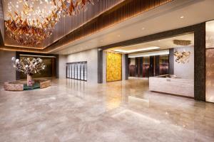 a lobby of a hotel with a chandelier at Maison L'OCCITANE in Macau