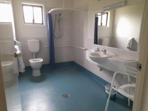 a bathroom with a toilet and a sink at Sundown Villas in Canberra