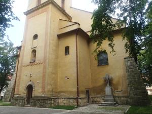 a church with a cross on the side of it at Penzión a Reštaurácia u Jeleňa in Stará Ľubovňa