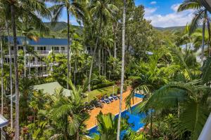 an aerial view of a resort with a pool and palm trees at Agincourt Beachfront Apartments in Clifton Beach