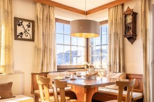 a dining room with a table and a large window at Ferienhaus Winkler in Anterivo
