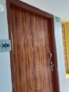 a wooden door with a swirl painted on it at Paradise corner in Puducherry