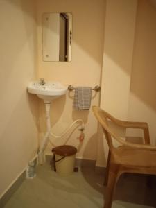 a bathroom with a sink and a toilet at Paradise corner in Puducherry