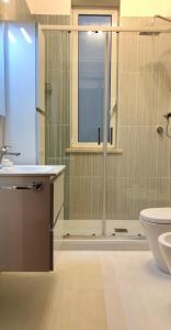 a bathroom with a shower and a toilet and a sink at Casa Kina Marsala in Marsala +15 photos