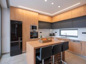 a kitchen with a island with a table and chairs at Ligaria Mare in Agia Pelagia