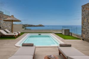 a swimming pool with a view of the ocean at Ligaria Mare in Agia Pelagia