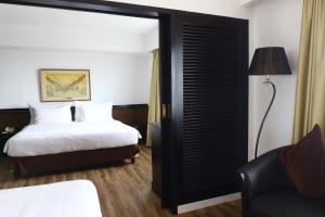 a hotel room with a bed and a black door at Jakarta Airport Hotel in Tangerang