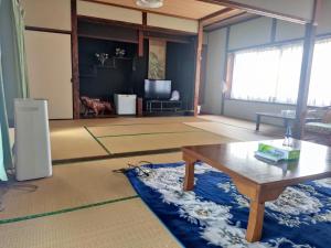 Iizukaあけぼの館的客厅配有咖啡桌和沙发