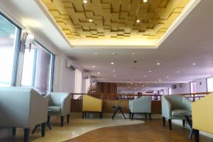 a restaurant with chairs and a coffered ceiling at Jakarta Airport Hotel in Tangerang