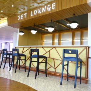 a group of blue chairs sitting at a bar at Jakarta Airport Hotel in Tangerang