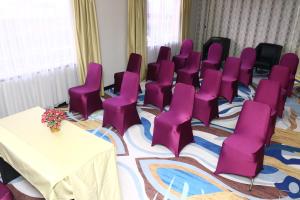 a conference room with purple chairs and a table at Jakarta Airport Hotel in Tangerang