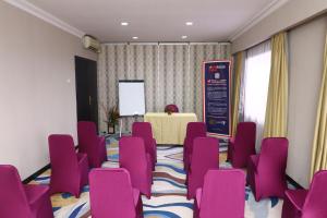 a conference room with purple chairs and a table at Jakarta Airport Hotel in Tangerang