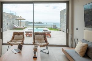 a living room with a view of the ocean at Ligaria Mare in Agia Pelagia