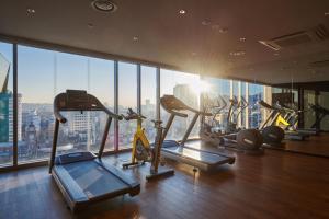 a gym with several tread machines in a building at Nine Tree Premier Hotel Insadong Myeongdong in Seoul