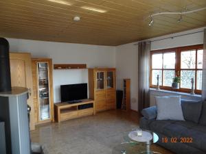 a living room with a couch and a television at Ferienwohnung Schwarz in Röttenbach