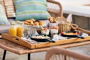 a tray of food on a table with food at Santa Maria Luxury Suites & Spa in Adamas