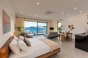 a bedroom with a large bed and a living room at Born in Blue in Kaş