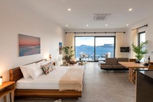 a hotel room with a bed and a living room at Born in Blue in Kaş