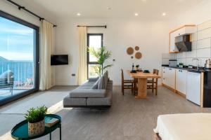 a living room with a couch and a table at Born in Blue in Kaş