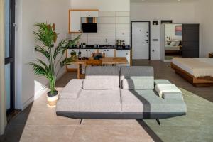 a living room with a couch and a bed at Born in Blue in Kaş