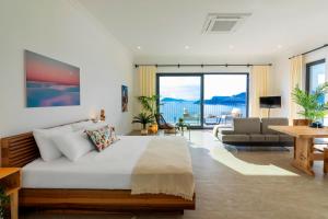 a bedroom with a bed and a living room at Born in Blue in Kaş