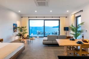 a bedroom with a bed and a view of the ocean at Born in Blue in Kaş