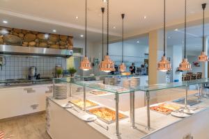 a restaurant with a buffet with food on display at Familienhotel Reiterhof Runding in Runding