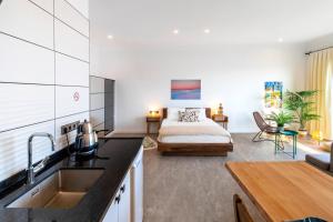 a kitchen and living room with a bed in a room at Born in Blue in Kaş
