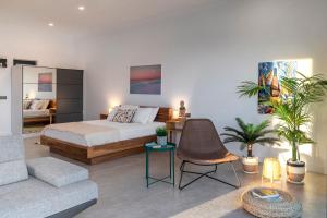 a bedroom with a bed and a living room at Born in Blue in Kaş
