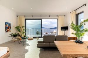 a living room with a couch and a table at Born in Blue in Kaş
