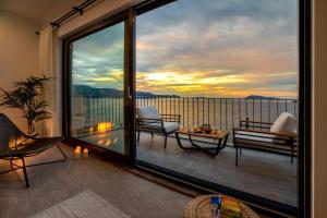 a room with a balcony with a view of the ocean at Born in Blue in Kaş