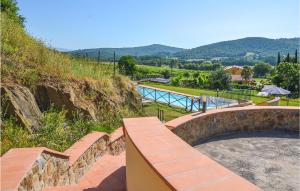 a view from the top of a hill with a stone wall at Beautiful Apartment In Bucine With Outdoor Swimming Pool in Bucine