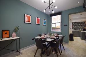 a dining room with a table and some chairs at Central Stays - Luxury 3 Bedroom House in Central Chester SLEEPS 6 in Chester