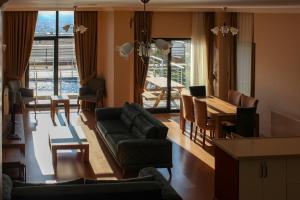 a living room with a couch and a table at Sawsana Villalari in Sapanca