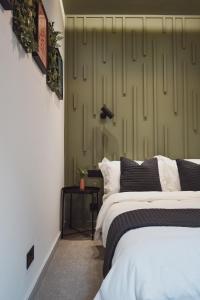 a bedroom with two beds and a green wall at Central Stays - Luxury 3 Bedroom House in Central Chester SLEEPS 6 in Chester