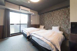 Tempat tidur dalam kamar di Kyoto Sanjo Ohashi