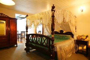 
a bed room with a bed with a canopy at The Firs in Nuwara Eliya
