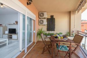 a dining room with a table and chairs on a balcony at La Casa de Bebita in Fuengirola