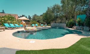 a swimming pool with a slide in a yard at Le President-Gare Nimes Pont Du Gard in Bellegarde