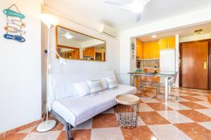 a living room with a couch and a table at Sunny Seaside Apartment in Arroyo de la Miel