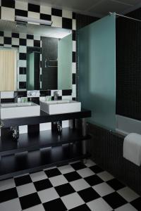 a bathroom with two sinks and a mirror at Hotel Slipway in Dar es Salaam