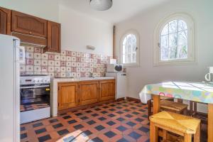 a kitchen with a refrigerator and a table in it at Uharte in Uhart-Cize +4 photos